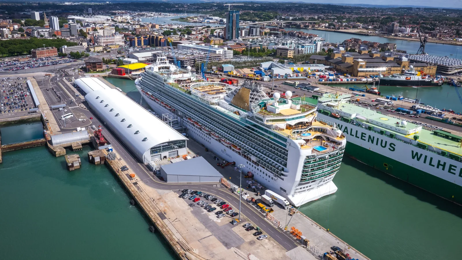A P&O cruise ship berthed at Southampton's Ocean Cruise Terminal, with the city centre and waterfront behind
